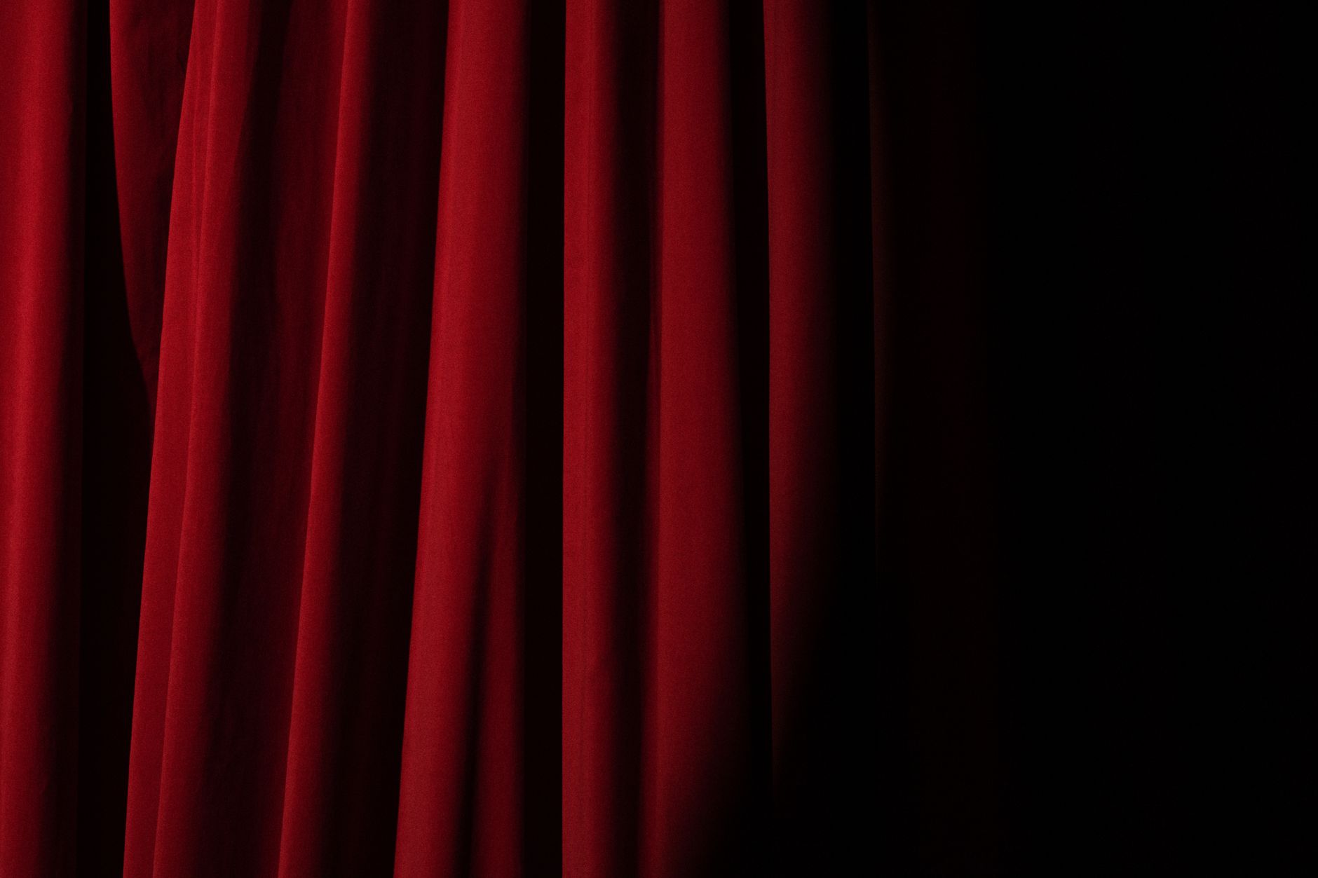 Deep red theater curtain before showtime