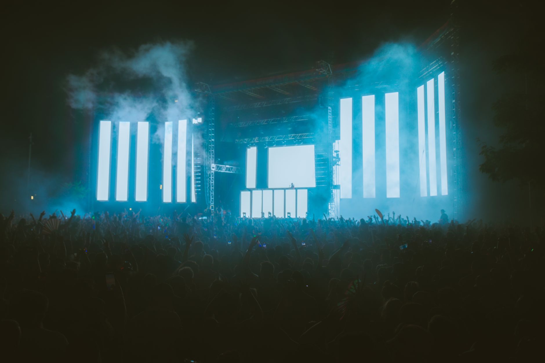 Stage lighting rig glowing over a live set